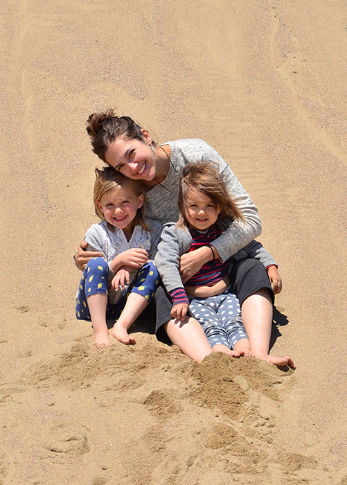 Brigitte Robitaille and her two girls sitting in the sand