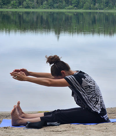 Brigitte Robitaille doing exercise by the lake