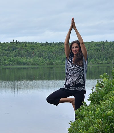 Brigitte Robitaille doing exercise by the lake